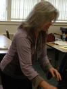 image of Tara McManaway leaning over to assist a student